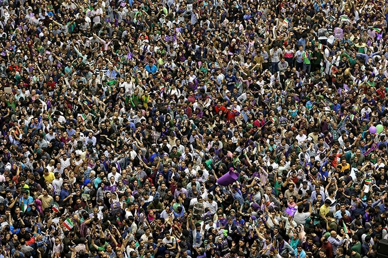 Supporters of Iranian President Hassan Rouhani for May 19 presidential election attend a campaign rally in Tehran, Iran, Saturday, May 13, 2017. Iran's President Hassan Rouhani has said that Friday's presidential election will place the country at a critical juncture, and its people must choose between peace or tension. Speaking Saturday to tens of thousands of his supporters at Tehran's Azadi Stadium, his biggest campaign rally thus far, Rouhani said, "We are at the edge of a great historical decision. Our nation will announce if it continues on the path of peacefulness or if it wants to choose tension."