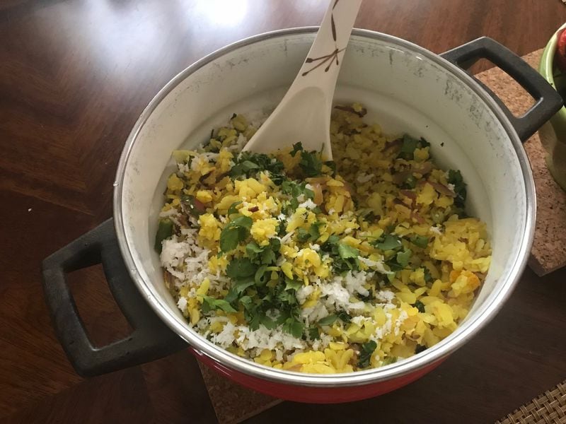 Pohe is a breakfast porridge of flattened rice seasoned with the likes of curry leaves, cilantro, coconut, cumin and turmeric. Courtesy of Gauri Misra-Deshpande