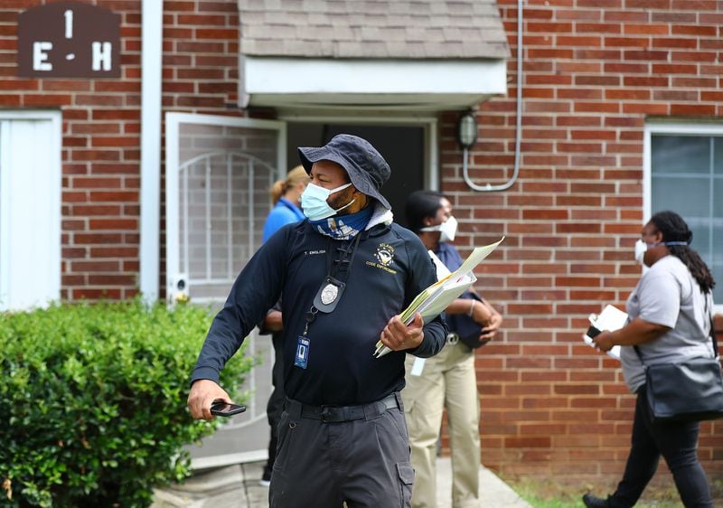 Atlanta code enforcement, zoning, and State Department of Community Affairs do a sweep of Pavilion Place apartments on Monday. Pavilion Place was one of the complexes featured in the AJC's Dangerous Dwellings investigative series. (Curtis Compton / Curtis Compton@ajc.com)