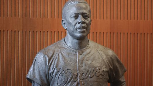 The Hank Aaron statue is shown by the grand staircase at the National Baseball Hall of Fame, Thursday, May 23, 2024, in Cooperstown, NY. (Jason Getz / AJC)

