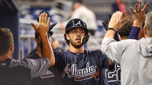 Dansby Swanson  of the Atlanta Braves celebrates hitting a homerun with teammates in the dugout during the second inning against the Miami Marlins at Marlins Park on July 23, 2018 in Miami, Florida. (Photo by Mark Brown/Getty Images)