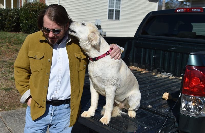 Lawson at home with his dog in Gainesville: “I was unsuccessful at hanging myself.” BRANT SANDERLIN/BSANDERLIN@AJC.COM
