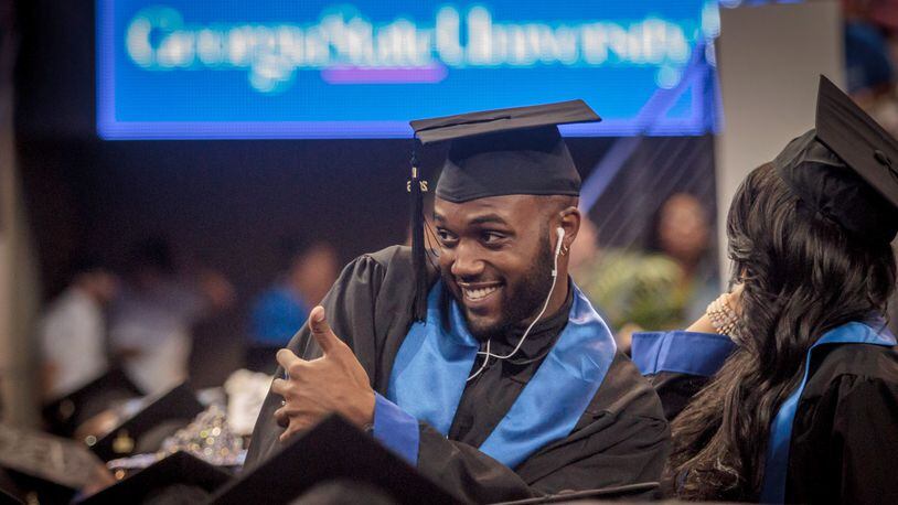 A Georgia State University student poses for a photograph before the start of his graduation ceremony in Atlanta last year.  How do we get more Georgians to this point?
