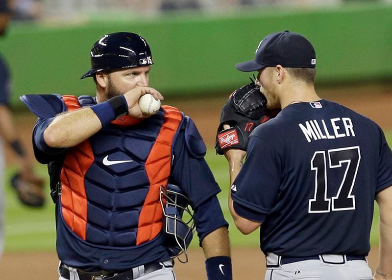 Atlanta Braves catcher A.J. Pierzynski, left, talks to Shelby Miller (17) after Miller gave up an infield hit to Miami Marlins' Christian Yelich (21) in the third inning of a baseball game, Wednesday, April 8, 2015, in Miami. (AP Photo/Alan Diaz) "Psst. I hear you're going to Arizona." (AP Photo/Alan Diaz)