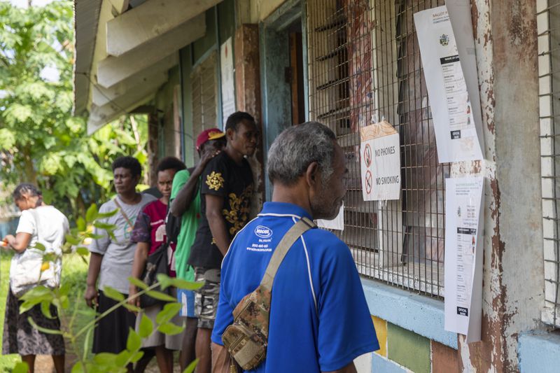Villagers queue to vote during the Solomon Islands elections in a village on the island of San Cristobal, Wednesday, April 17, 2024. Voting has closed across Solomon Islands on Wednesday in the South Pacific nation's first general election since the government switched diplomatic allegiances from Taiwan to Beijing and struck a secret security pact that has raised fears of the Chinese navy gaining a foothold in the region.(AP Photo/Charley Piringi)