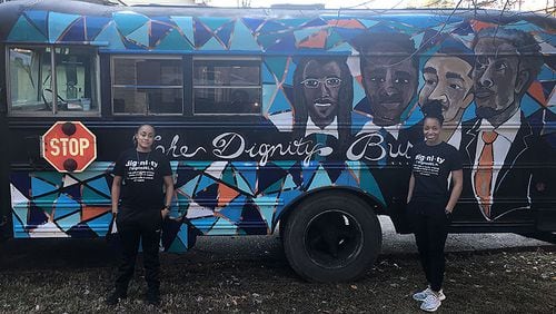 Bridge of Light Atlanta founders Ray Young (left) and Torrie Everheart pose in front of The Dignity Bus.