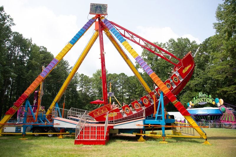People take to the air on one of the carnival rides during the Lemonade Days Festival in Dunwoody on Sunday, August 22, 2021. STEVE SCHAEFER FOR THE ATLANTA JOURNAL-CONSTITUTION
