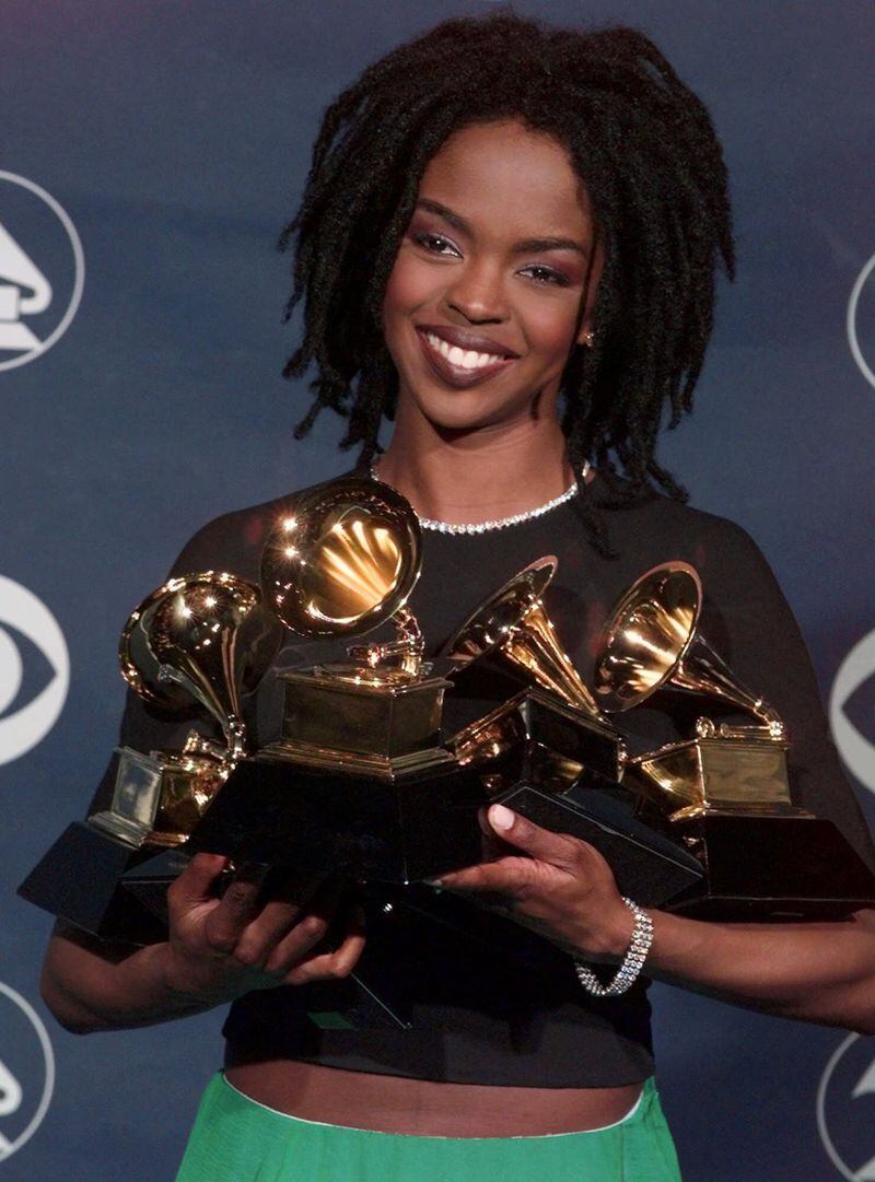 Lauryn Hill holds her five Grammy Awards during the 41st Annual Grammy Awards at the Shrine Auditorium in Los Angeles on Feb. 24, 1999. (AP Photo/Reed Saxon)