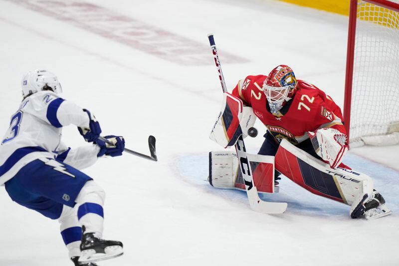 Tampa Bay Lightning center Michael Eyssimont (23) attempts a shot at Florida Panthers goaltender Sergei Bobrovsky (72) during the first period of Game 1 of the first-round of an NHL Stanley Cup Playoff series, Sunday, April 21, 2024, in Sunrise, Fla. (AP Photo/Wilfredo Lee)