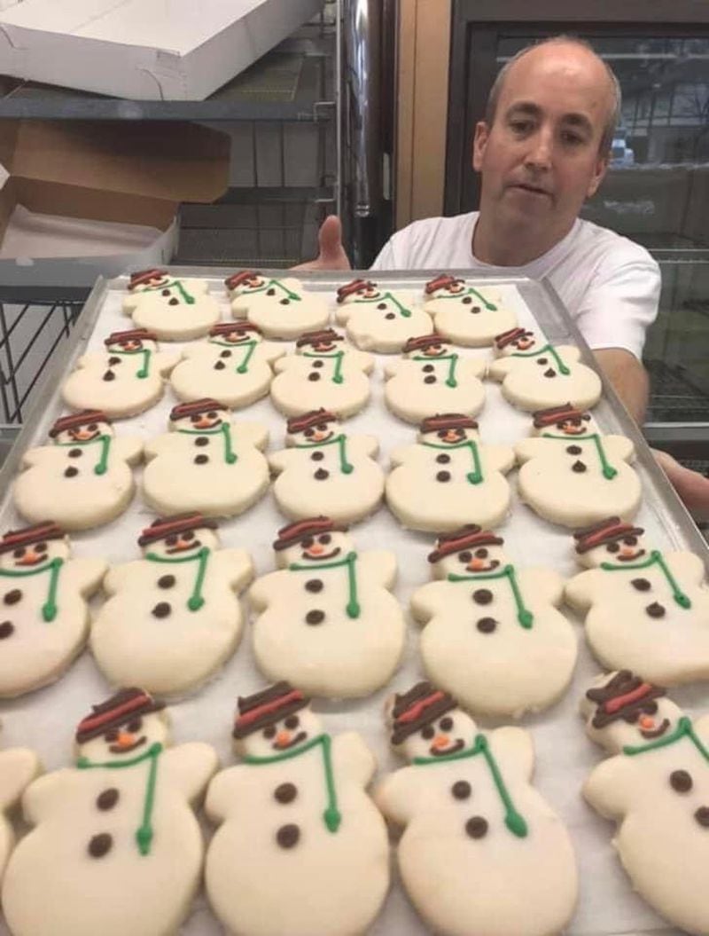 George Rhodes of Rhodes Bakery displays a sheet of festive cookies. The bakery announced it was closing after 68 years on Cheshire Bridge Road. Photo by Jeff Hullinger