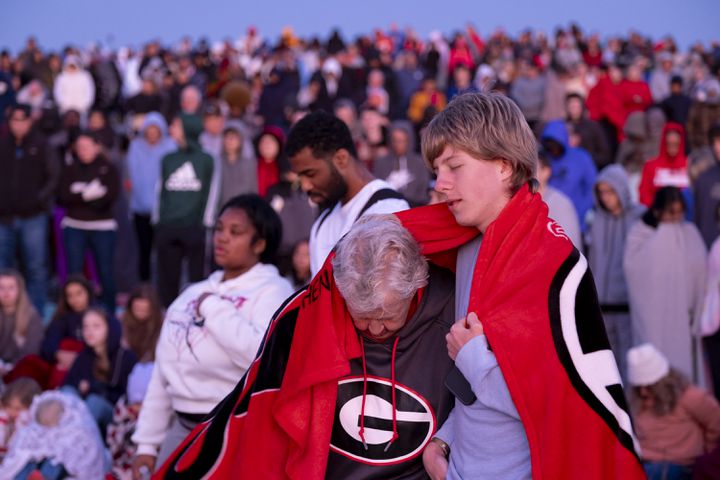 Janet Pannell and her nephew Wesley Pannell pray while huddled together for warmth during Easter sunrise service on top of Stone Mountain on Sunday, March 31, 2024.   (Ben Gray / Ben@BenGray.com)