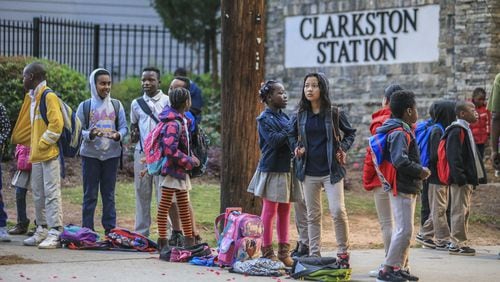 Students from Idlewood Elementary School wait for their bus in the 1000 block of Montreal Road in Clarkston on Thursday, April 19, 2018. JOHN SPINK/JSPINK@AJC.COM
