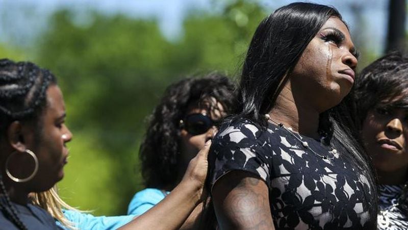 Muhlaysia Booker is comforted April 20, 2019, as she speaks during a rally in Dallas. Booker, a 22-year-old transgender woman seen on video being beaten April 12 in front of a crowd, was found shot to death Saturday, May 18 on a Dallas street.