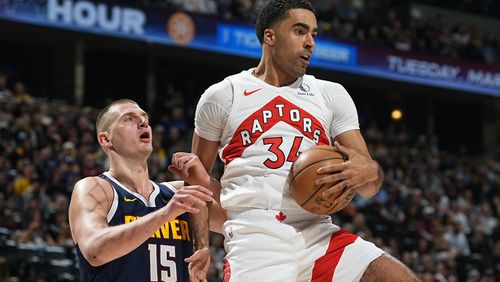 FILE - Toronto Raptors center Jontay Porter, right, pulls in a rebound as Denver Nuggets center Nikola Jokic, left, defends in the first half of an NBA basketball game Monday, March 11, 2024, in Denver. The NBA banned Toronto two-way player Jontay Porter on Wednesday, April 17, 2024, after a league probe found he disclosed confidential information to sports bettors and bet on games.(AP Photo/David Zalubowski, File)