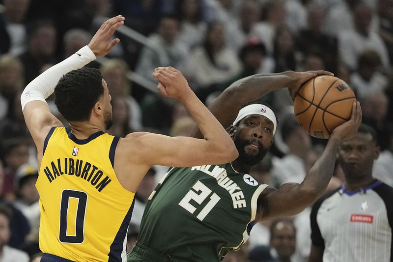 Milwaukee Bucks' Patrick Beverley looks to pass around Indiana Pacers' Tyrese Haliburton during the first half of Game 2 of the NBA playoff basketball game Tuesday, April 23, 2024, in Milwaukee. (AP Photo/Morry Gash)