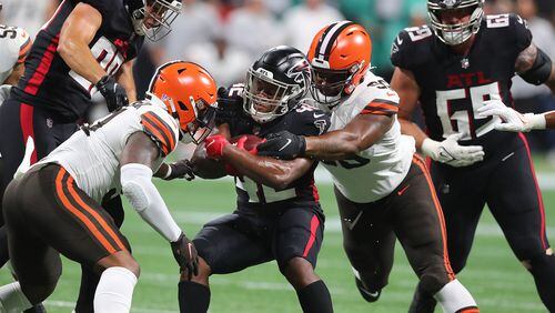 Falcons running back Caleb Huntley is sandwiched by Cleveland Browns defenders for short yardage during the first half Sunday, Aug. 29, 2021, in Atlanta. “Curtis Compton / Curtis.Compton@ajc.com”
