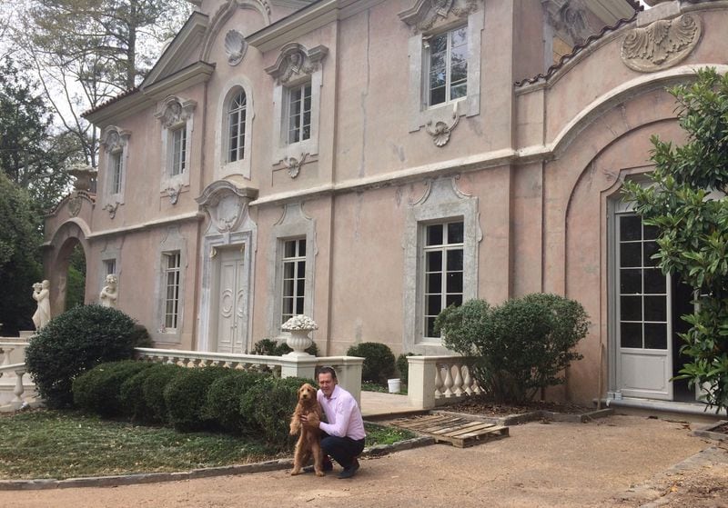 Thierry Francois and his dog Simba outside the Pink Palace, the latest historic preservation battlefront in Buckhead. Photo by Bill Torpy