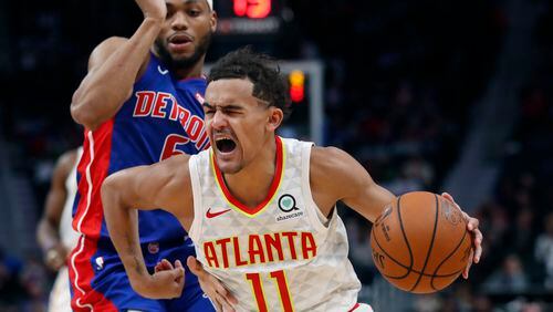 Hawks guard Trae Young (11) drives on Detroit Pistons guard Bruce Brown during the second half of an NBA basketball game Friday, Nov. 22, 2019, in Detroit. (AP Photo/Carlos Osorio)