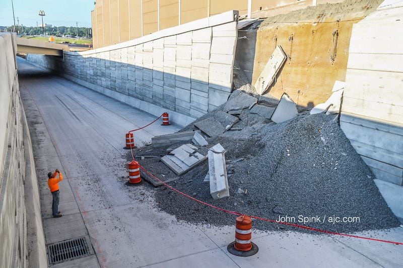 A retaining wall collapsed onto an unfinished portion of toll lanes that sit along I-75 and Windy Hill Road in Cobb County. JOHN SPINK / JSPINK@AJC.COM