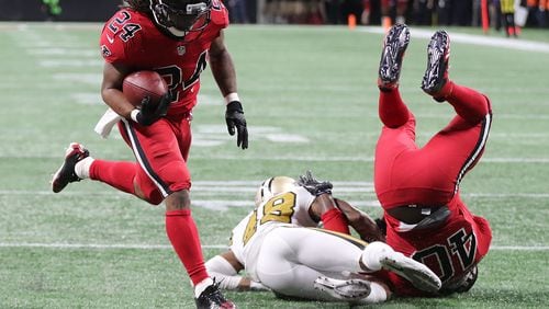 December 7, 2017 Atlanta: Falcons fullback Derrick Coleman levels Saints safety Vonn Bell opening the hole for running back Devonta Freeman to score a touchdown to take a 10-3 lead during the second quarter in a NFL football game on Thursday, December 7, 2017, in Atlanta.  Curtis Compton/ccompton@ajc.com