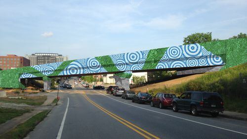 This rendering is of the mural for the MARTA overpass at West Trinity Place and Atlanta Avenue in Decatur. Though it’s impossible to see here, on closer inspection the green ribbon becomes a deeply nuanced tapestry of chameleons, caterpillars, snakes, blueberries, salamanders and other local plants and animals. Courtesy of the Decatur Arts Alliance