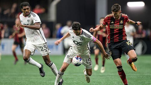 D.C. United defender Donovan Pines (23) and Atlanta United forward Miguel Berry (19) watch as D.C. United forward Nigel Robertha (19) maneuvers the ball during the second half of an MLS math Saturday, June 10, 2023 at Mercedes Benz Stadium. (Daniel Varnado/ For the AJC)