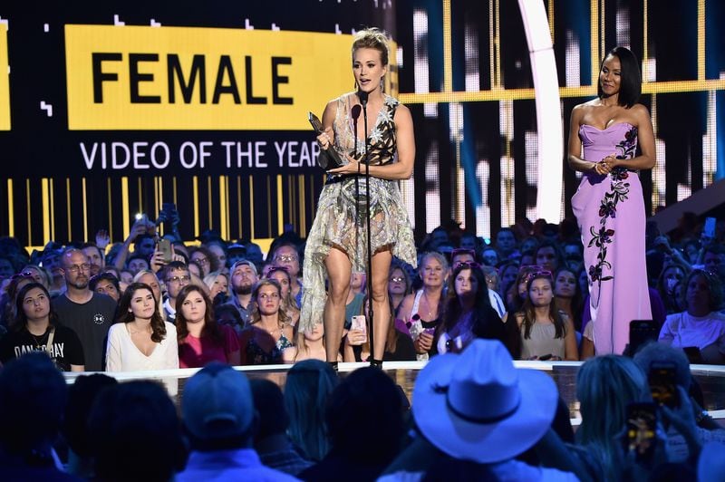  NASHVILLE, TN - JUNE 07: Jada Pinkett Smith (R) presents Carrie Underwood (L) with the award for Female Video of the Year onstage during the 2017 CMT Music Awards at the Music City Center on June 6, 2017 in Nashville, Tennessee. (Photo by Michael Loccisano/Getty Images for CMT)