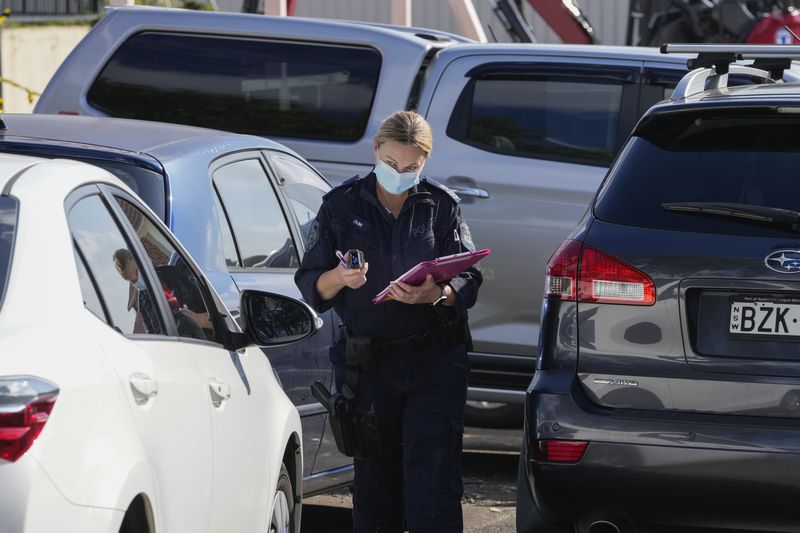 A police forensic officer works near cars outside the Christ the Good Shepherd Church in suburban Wakely in western Sydney, Australia, Tuesday, April 16, 2024. Australian police say a knife attack in Sydney that wounded a bishop and a priest during a church service as horrified worshippers watched online and in person, and sparked a riot was an act of terrorism. (AP Photo/Mark Baker)