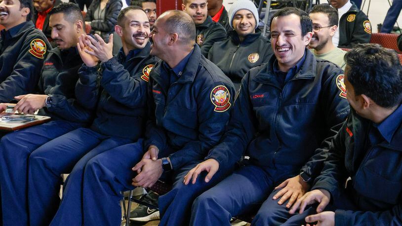 Six Saudi Aramco firefighters are all smiles after they graduated from a six-month international training program with the Atlanta Fire and Rescue Department.