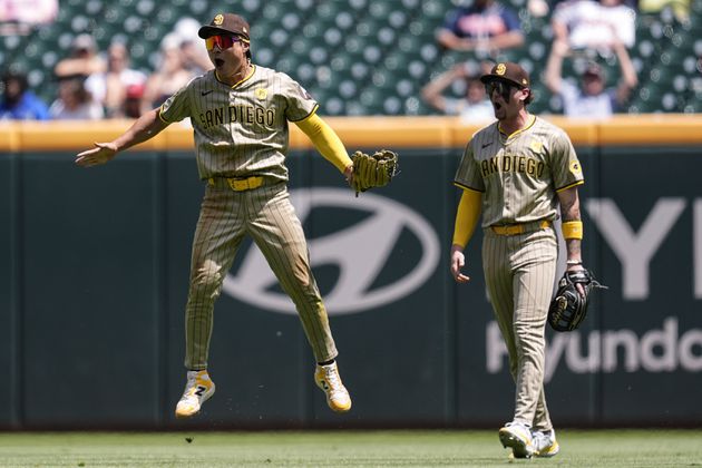Padres shortstop Ha-Seong Kim (7) celebrates his catch of Michael Harris' attempted hit in the ninth inning of Monday's 6-5 victory over the Braves in Game 1 of a doubleheader at Truist Park. (AP Photo/Mike Stewart)