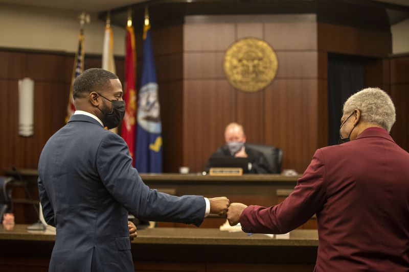 01/22/2021 —Marietta, Georgia — U.S. Military Veterans Kenneth (left) and Edward (right) congratulate each other with a fist-bump after they both graduated from the Veterans Accountability and Treatment Court in Cobb Superior Court at the Cobb County Superior Courthouse, Friday, January 22, 2021. (Alyssa Pointer / Alyssa.Pointer@ajc.com) [Last names are withheld by request of judge.]