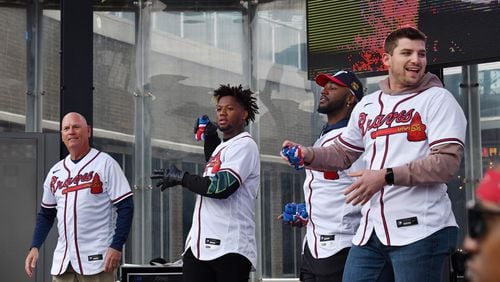 Atlanta Braves (from left) manger Brian Snitker, right fielder Ronald Acuña, center fielder Michael Harris and third baseman Austin Riley throw free t-shirts during Braves Fest Opening Rally at Georgia Power Pavilion Stage in The Battery Atlanta, Saturday, Jan. 21, 2023, in Atlanta. After not holding the event for several years due to the pandemic, the team will bring back the fan event Saturday. Fan Fest will be held at Truist Park and The Battery from 10 a.m. to 4 p.m. The free event will feature player autographs and photos, Q&A sessions, clinics, games, on-field activities, live entertainment and panel discussions with players and coaches. (Hyosub Shin / Hyosub.Shin@ajc.com)