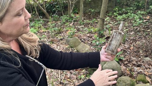 Many objects, like this bottle, have been unearthed in Elizabeth Burns’ lead-contaminated Atlanta yard. (Andy Miller/KFF Health News)