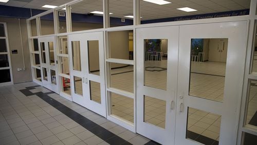 New security doors and a check-in window were under construction at Johns Creek Elementary School in Suwanee last July. (Alyssa Pointer/alyssa.pointer@ajc.com)