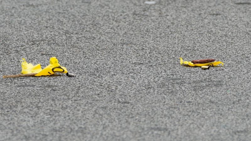 Shell casings are seen marked by crime scene tape outside the Luxury Nail Spa in East Point. 