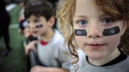 Finley Offen  waits for her chance to participate in football drills during the Playoff Fan Central at the Georgia World Congress Center Saturday In Atlanta GA January 6, 2018. The Playoff Fan Central, a 300,000 square-foot interactive experience runs through Monday. STEVE SCHAEFER / SPECIAL TO THE AJC