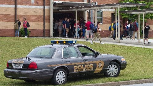 Students leave Woodstock High School on Friday after a school lockdown was lifted. STEVE SCHAEFER / SPECIAL TO THE AJC