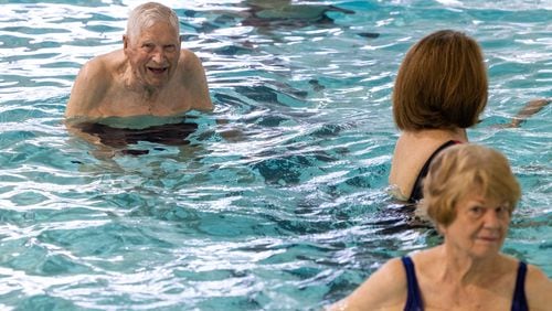 A 104-year-old WWII veteran, Charlie Duncan (upper left) does water aerobics three days a week at the Mountain View Aquatic Center in east Cobb. PHIL SKINNER FOR THE ATLANTA JOURNAL-CONSTITUTION 