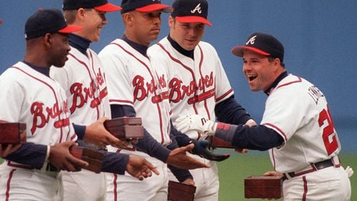 Mark Lemke celebrates with teammates upon receiving his 1995 World Series ring in April 1996. From left, Marquis Grissom, Chipper Jones, David Justice and Ryan Klesko. It came after heartbreaking Series losses in 1991-92. (Frank Niemeir / AJC staff)