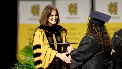 Kennesaw State University President Kathy “Kat” Schwaig greets graduates during the Spring 2022 Commencement for the Radow College of Humanities and Social Sciences at the Convocation Center two weeks ago. Schwaig is creating a $100,000 need-based scholarship from her own funds. (Jason Getz / Jason.Getz@ajc.com)
