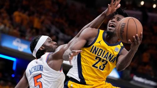 Indiana Pacers forward Aaron Nesmith (23) shoots over New York Knicks forward Precious Achiuwa (5) during the second half of Game 6 in an NBA basketball second-round playoff series, Friday, May 17, 2024, in Indianapolis. (AP Photo/Michael Conroy)