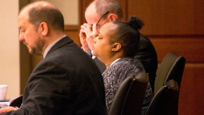 Erica White, center, takes a deep breath during the start of her trial at Cobb County Superior Court, Monday, January 22, 2018. Erica Claudette White is on trial for the death of her 2-year-old son.