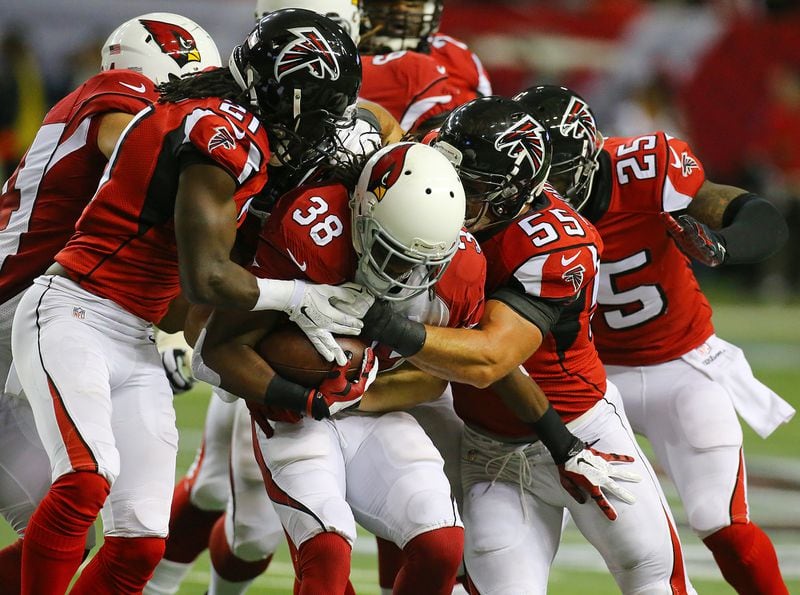 113014 ATLANTA: Falcons defenders Desmond Trufant ( left) and Paul Worrilow stop Cardinals running back Andre Ellington for a short gain during the first half in an NFL football game on Sunday, Nov. 30, 2014, in Atlanta. CURTIS COMPTON / CCOMPTON@AJC.COM 113014 ATLANTA: Falcons defenders Desmond Trufant ( left) and Paul Worrilow stop Cardinals running back Andre Ellington for a short gain during the first half in an NFL football game on Sunday, Nov. 30, 2014, in Atlanta. CURTIS COMPTON / CCOMPTON@AJC.COM