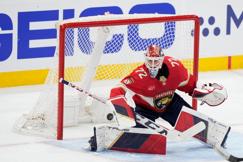 Florida Panthers goaltender Sergei Bobrovsky deflects a shot during the second period of Game 1 of the first-round of an NHL Stanley Cup Playoff series against the Tampa Bay Lightning, Sunday, April 21, 2024, in Sunrise, Fla. (AP Photo/Wilfredo Lee)