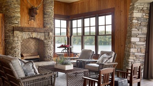 Wood, stone and a view of water and trees outside allow this indoor space from Carter Kay Interiors to embrace the outdoors. Courtesy of Carter Kay Interiors