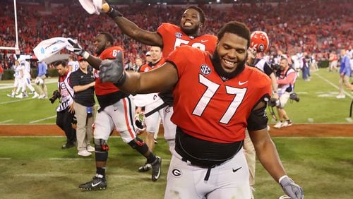 November 18, 2017 Athens: Georgia senior offensive lineman Isaiah Wynn and the Bulldogs celebrate a 42-13 vicotry over Kentucky in a NCAA college football game on Saturday, November 18, 2017, in Athens.    Curtis Compton/ccompton@ajc.com