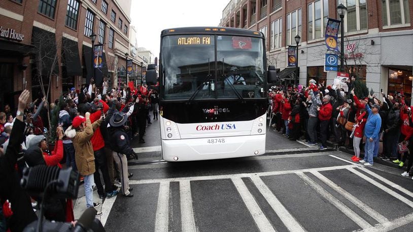 Buses carrying the Atlanta Falcons NFL football team are greeted by cheering fans during a send-off pep rally as they make their way to the airport for a flight to Houston and Super Bowl LI, Sunday, Jan. 29, 2017, in Atlanta. John Bazemore/ AP Photo/John Bazemore