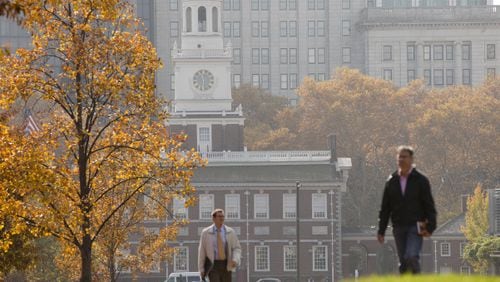 In this Nov. 12, 2014 file photo, people walk in view of Independence Hall in Philadelphia. Under President Dwight D. Eisehower, the nation prepared for the 50th birthday of the National Park Service with a spending splurge that refurbished Independence Hall in Philadelphia and helped complete the Gateway Arch in St. Louis and the 469-mile Blue Ridge Parkway.  (AP Photo/Matt Rourke, File)