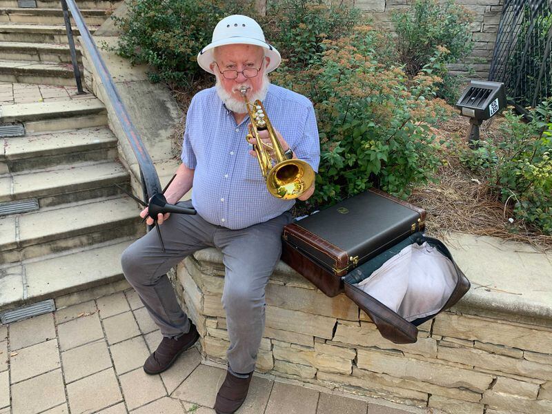 Oscar Jones, 70, has been playing the trumpet for racers every year since 2013 at the Covenant Presbyterian Church along the race route. (Photo: Isaiah Poritz/AJC)