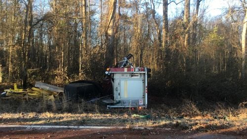 Driver Artis Johnson and firefighter Michael Murray were taken to Piedmont Walton Hospital in Monroe with moderate injuries, Walton County Fire Rescue officials said.